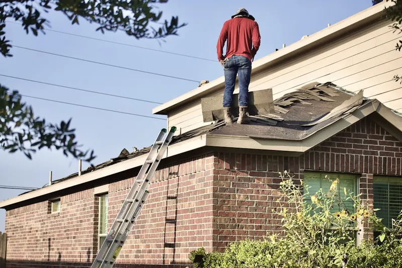 Professional roofer working on a residential roof in Stoughstown